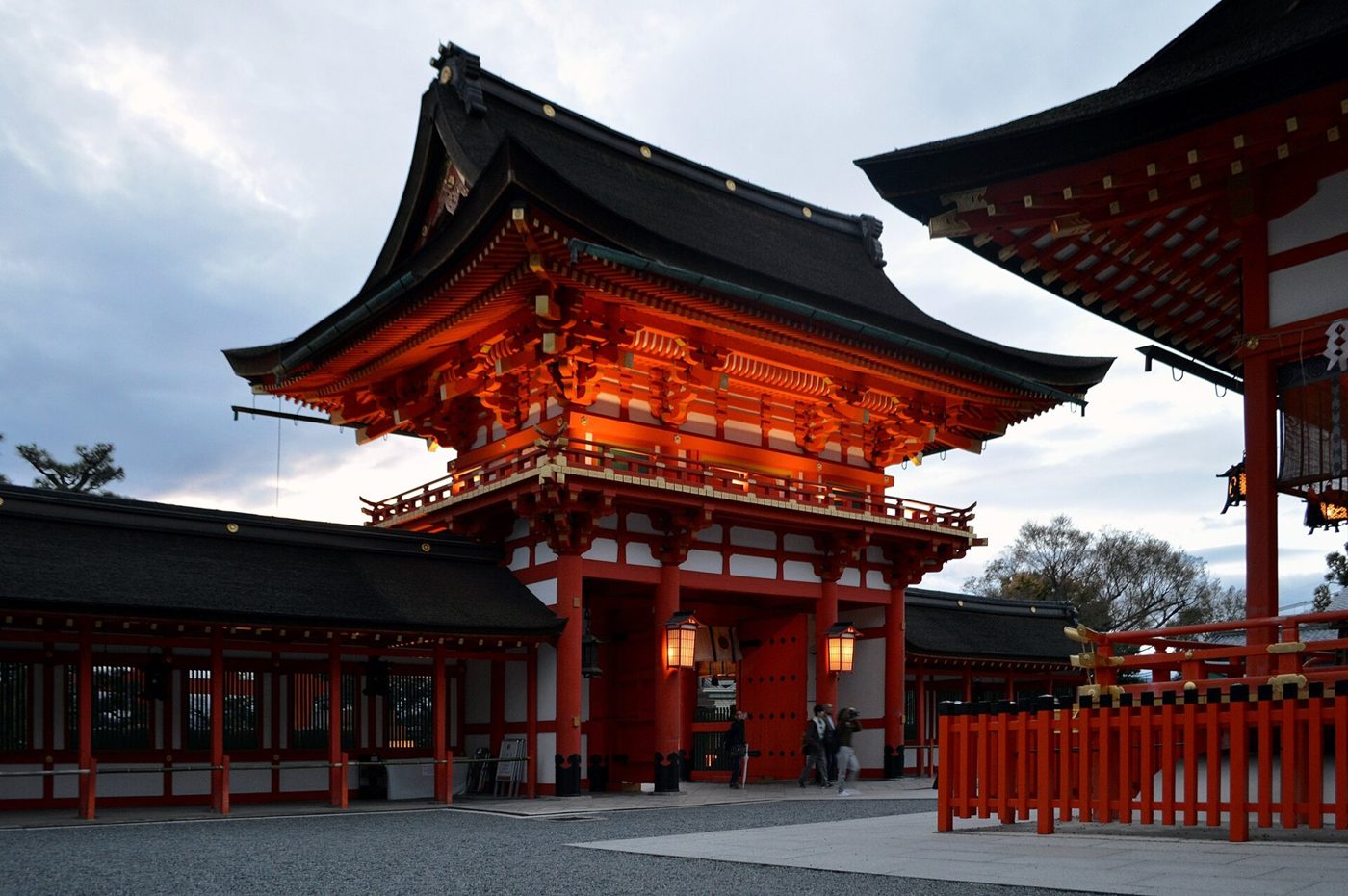 The great orange gate of Fushimi Inari Shrine at dusk
