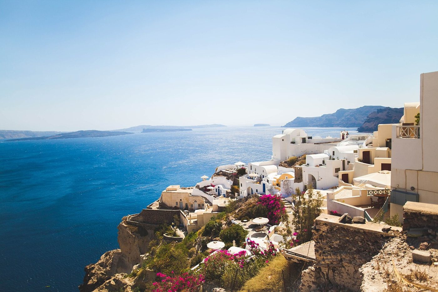 White houses of Santorini on the cliff above the blue Aegean Sea