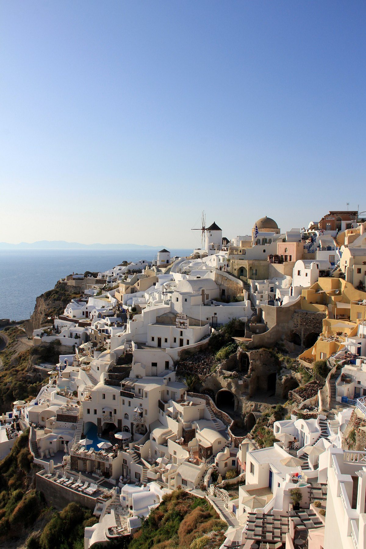 Whitewashed village of Oia with windmills on the Santorini cliffs